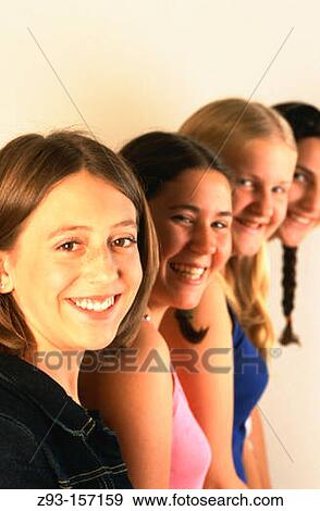 Stock Photo - Four teen girls in a row. Fotosearch