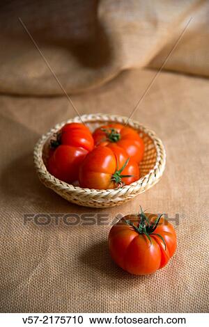Four tomatoes, three of them in a basket. Still life. View Large Photo Image Stock Image - Four tomatoes, three of them in a basket. Still life.. Fotosearch