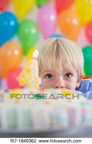 Stock Image - Four year old boy celebrating his birthday. Fotosearch