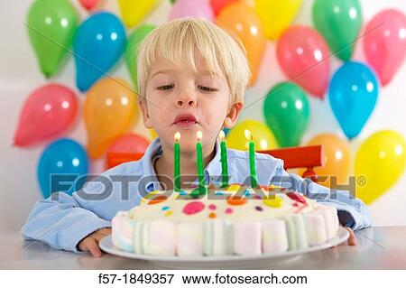 Four year old boy celebrating his birthday View Large Photo Image Stock Photo - Four year old boy celebrating his birthday. Fotosearch