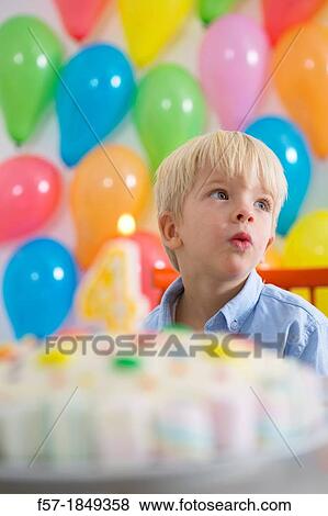 Stock Photo - Four year old boy celebrating his birthday. Fotosearch