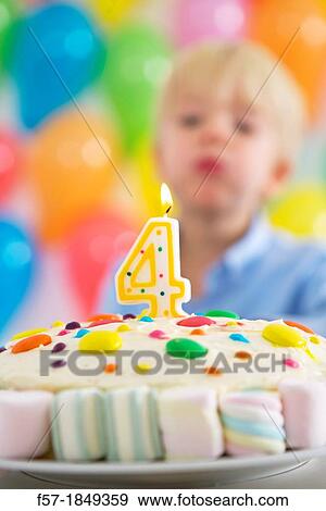 Stock Photo - Four year old boy celebrating his birthday. Fotosearch