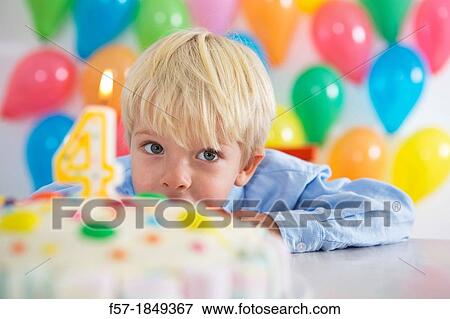 Stock Photo - Four year old boy celebrating his birthday. Fotosearch