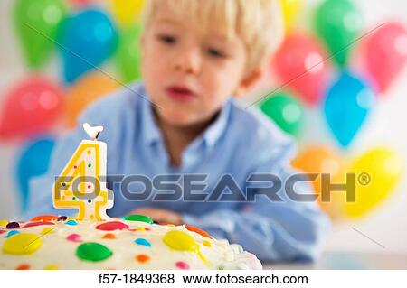 Four year old boy celebrating his birthday View Large Photo Image Stock Photo - Four year old boy celebrating his birthday. Fotosearch