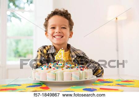Four year old boy celebrating his birthday View Large Photo Image Stock Photo - Four year old boy celebrating his birthday. Fotosearch