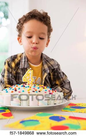Four year old boy celebrating his birthday View Large Photo Image Stock Photo - Four year old boy celebrating his birthday. Fotosearch