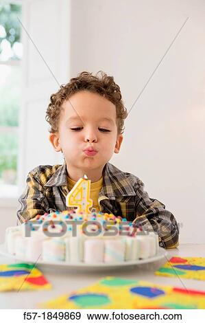 Four year old boy celebrating his birthday View Large Photo Image Stock Photo - Four year old boy celebrating his birthday. Fotosearch