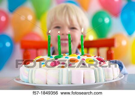 Four year old boy celebrating his birthday View Large Photo Image Stock Photograph - Four year old boy celebrating his birthday. Fotosearch