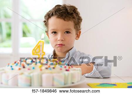 Four year old boy celebrating his birthday View Large Photo Image Stock Photograph - Four year old boy celebrating his birthday. Fotosearch