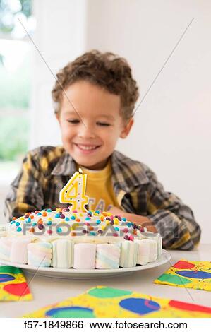 Four year old boy celebrating his birthday View Large Photo Image Stock Photograph - Four year old boy celebrating his birthday. Fotosearch