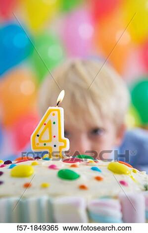 Stock Photography - Four year old boy celebrating his birthday. Fotosearch