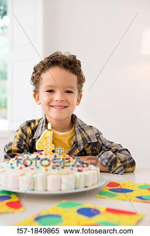 Stock Photography - Four year old boy celebrating his birthday. Fotosearch
