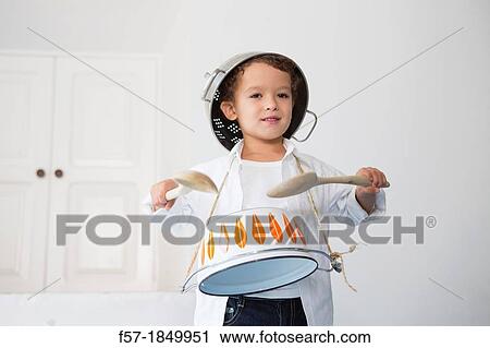 Four year old boy drumming on a saucepan View Large Photo Image Stock Image - Four year old boy drumming on a saucepan. Fotosearch