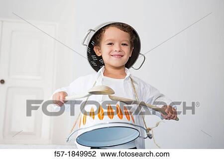 Four year old boy drumming on a saucepan View Large Photo Image Stock Image - Four year old boy drumming on a saucepan. Fotosearch