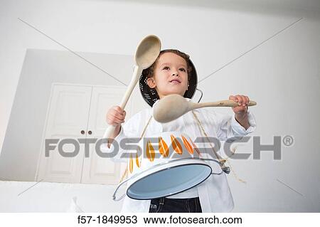 Four year old boy drumming on a saucepan View Large Photo Image Stock Image - Four year old boy drumming on a saucepan. Fotosearch