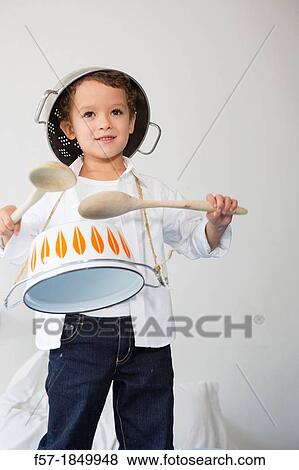 Four year old boy drumming on a saucepan View Large Photo Image Stock Photo - Four year old boy drumming on a saucepan. Fotosearch