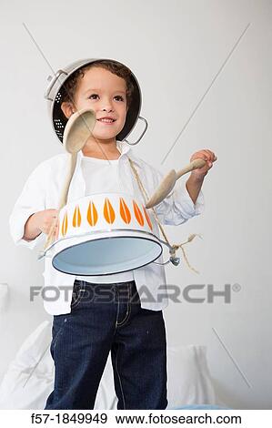 Four year old boy drumming on a saucepan View Large Photo Image Stock Photo - Four year old boy drumming on a saucepan. Fotosearch