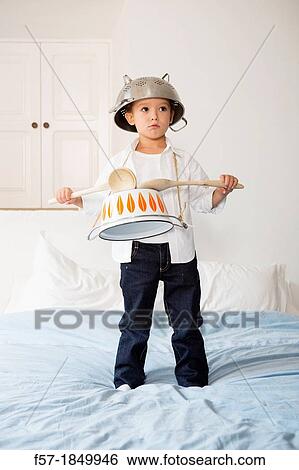Four year old boy drumming on a saucepan View Large Photo Image Stock Photograph - Four year old boy drumming on a saucepan. Fotosearch