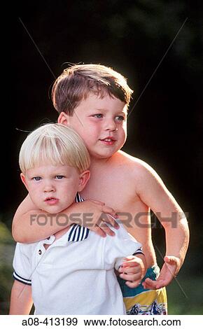 Four year old boy hugs two year old boy. USA. View Large Photo Image Stock Photo - Four year old boy hugs two year old boy. USA.. Fotosearch