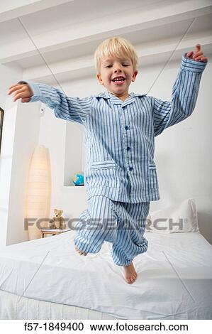 Four year old boy jumping off the bed View Large Photo Image Stock Image - Four year old boy jumping off the bed. Fotosearch