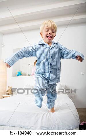Four year old boy jumping off the bed View Large Photo Image Stock Image - Four year old boy jumping off the bed. Fotosearch