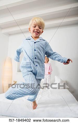 Four year old boy jumping off the bed View Large Photo Image Stock Image - Four year old boy jumping off the bed. Fotosearch