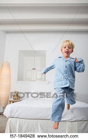 Four year old boy jumping off the bed View Large Photo Image Stock Photo - Four year old boy jumping off the bed. Fotosearch