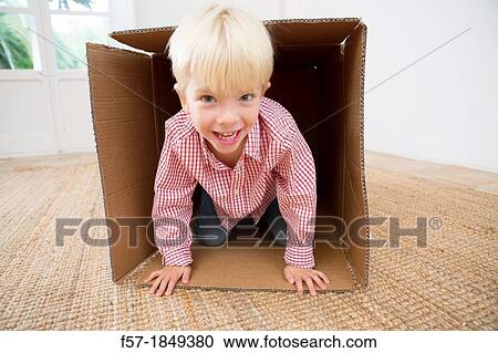 Four year old boy playing in a cardboard box View Large Photo Image Stock Image - Four year old boy playing in a cardboard box. Fotosearch