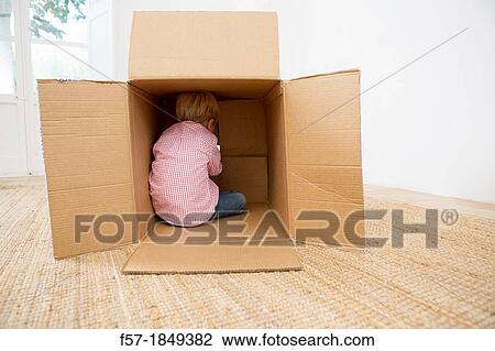 Four year old boy playing in a cardboard box View Large Photo Image Stock Image - Four year old boy playing in a cardboard box. Fotosearch