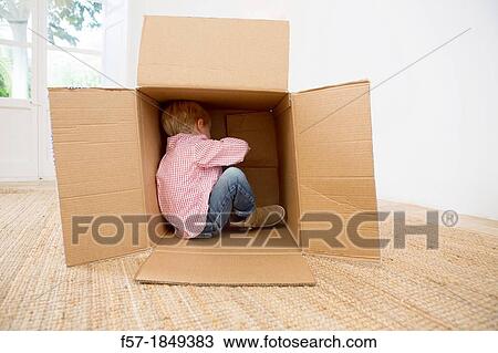Four year old boy playing in a cardboard box View Large Photo Image Stock Image - Four year old boy playing in a cardboard box. Fotosearch