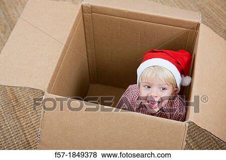 Four year old boy playing in a cardboard box View Large Photo Image Stock Photo - Four year old boy playing in a cardboard box. Fotosearch