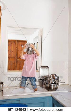 Four year old boy playing in the kitchen sink View Large Photo Image Stock Image - Four year old boy playing in the kitchen sink. Fotosearch
