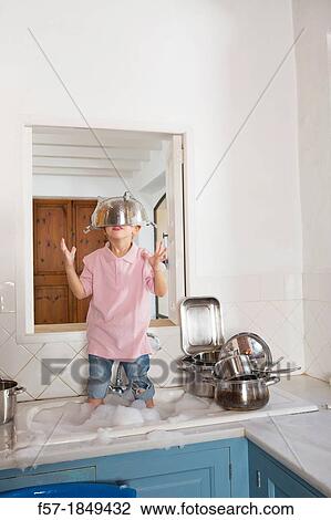 Four year old boy playing in the kitchen sink View Large Photo Image Stock Image - Four year old boy playing in the kitchen sink. Fotosearch
