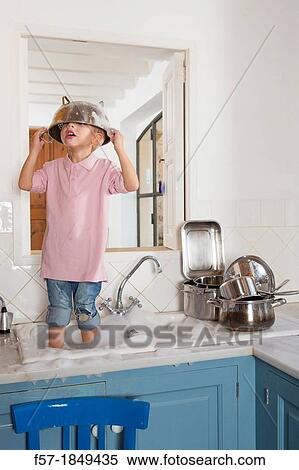 Four year old boy playing in the kitchen sink View Large Photo Image Stock Photography - Four year old boy playing in the kitchen sink. Fotosearch