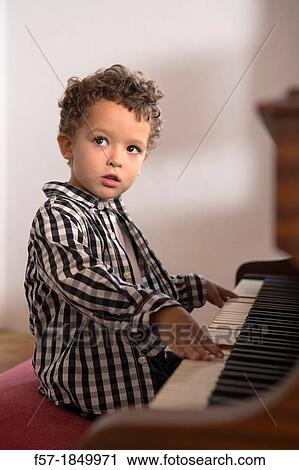 Four year old boy playing the piano View Large Photo Image Stock Image - Four year old boy playing the piano. Fotosearch