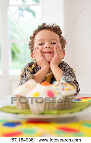 Four year old boy waiting for a cupcake View Large Photo Image Stock Image - Four year old boy waiting for a cupcake. Fotosearch