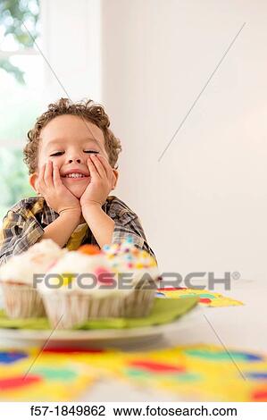 Four year old boy waiting for a cupcake View Large Photo Image Stock Image - Four year old boy waiting for a cupcake. Fotosearch
