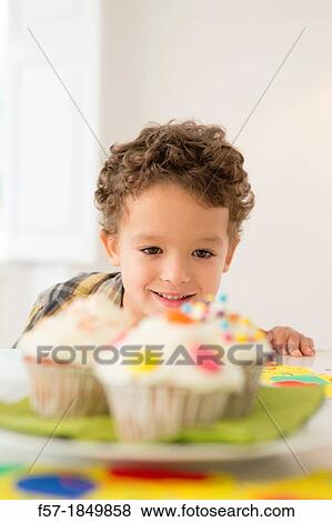 Four year old boy waiting for a cupcake View Large Photo Image Stock Photo - Four year old boy waiting for a cupcake. Fotosearch