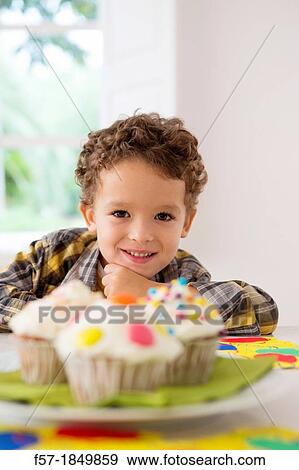 Four year old boy waiting for a cupcake View Large Photo Image Stock Photo - Four year old boy waiting for a cupcake. Fotosearch