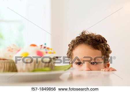 Four year old boy waiting for a cupcake View Large Photo Image Stock Photograph - Four year old boy waiting for a cupcake. Fotosearch