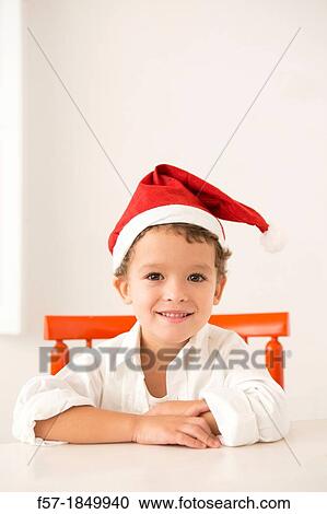 Four year old boy wearing a santa hat at Christmas View Large Photo Image Stock Image - Four year old boy wearing a santa hat at Christmas. Fotosearch