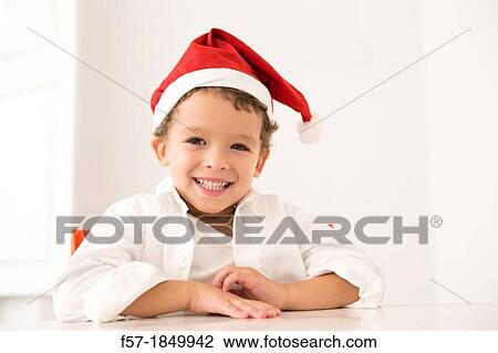 Four year old boy wearing a santa hat at Christmas View Large Photo Image Stock Image - Four year old boy wearing a santa hat at Christmas. Fotosearch
