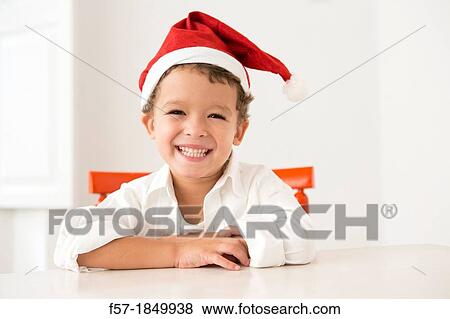 Four year old boy wearing a santa hat at Christmas View Large Photo Image Stock Photo - Four year old boy wearing a santa hat at Christmas. Fotosearch
