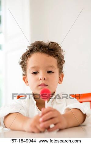 Four year old boy with a red lollipop View Large Photo Image Picture - Four year old boy with a red lollipop. Fotosearch