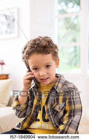 Picture - Four year old boy with cell phone. Fotosearch