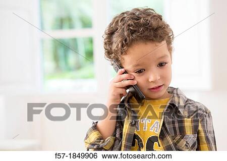 Four year old boy with cell phone View Large Photo Image Stock Photograph - Four year old boy with cell phone. Fotosearch
