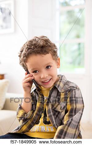 Stock Photography - Four year old boy with cell phone. Fotosearch