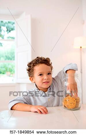 Four year old boy with his hand in the cookie jar View Large Photo Image Picture - Four year old boy with his hand in the cookie jar. Fotosearch