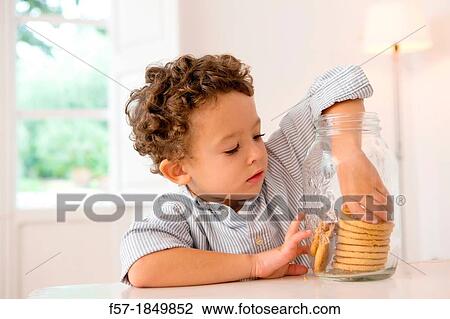 Four year old boy with his hand in the cookie jar View Large Photo Image Stock Image - Four year old boy with his hand in the cookie jar. Fotosearch