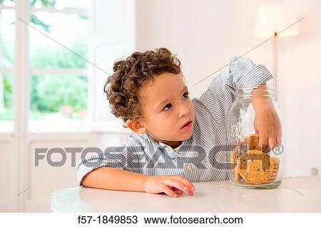 Four year old boy with his hand in the cookie jar View Large Photo Image Stock Image - Four year old boy with his hand in the cookie jar. Fotosearch